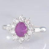 Anello a margherita vintage in platino con rubino stellato (1.35ct) e diamanti (0.66ctw ca.), anni ‘90