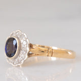 Anello a margherita vintage in oro giallo e bianco 9K con zaffiro (0.60ct ca.) e diamanti (0.12ctw ca.), anno 1991