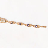 Braccialetto semirigido in oro giallo 14K con decorazioni floreali con smalti bianchi, rossi, verdi e blu e con lavorazioni a traforo, anni ‘50/‘60