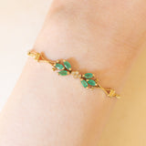 Braccialetto semirigido in oro giallo 14K con smeraldi (0.50ctw ca.) e diamanti (0.02ctw ca.), anni ‘70/‘80