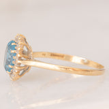 Anello a margherita vintage in oro giallo 9K con topazio azzurro (1.50ct ca.) e diamanti (0.10ctw ca.), anno 1988