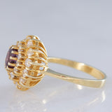 Anello a fiore vintage in oro giallo 14K con rubino (1ct ca.) e diamanti di taglio brillante (0.70ctw ca.), anni ‘70