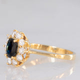 Anello a margherita vintage in oro giallo 18K con zaffiro (0.70ct ca.) e diamanti di taglio brillante (0.40ctw ca.), anni ‘80/‘90