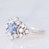Anello a margherita vintage in platino con zaffiro (0.60ct) e diamanti (0.41ctw), anni ‘90