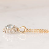 Collana vintage con catenina in oro giallo 9K e con ciondolo a margherita in oro giallo 9K con acquamarina (0.30ct ca.) e diamanti (0.06ctw ca.)