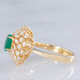 Anello ballerina vintage in oro giallo 14K con smeraldo (0.50ct ca.) e diamanti di taglio brillante e tapered (0.96ctw ca.), anni ‘80