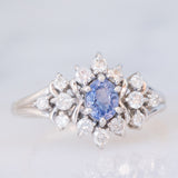 Anello a margherita vintage in platino con zaffiro (0.60ct) e diamanti (0.41ctw), anni ‘90