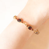 Braccialetto semirigido vintage in oro giallo 8K con granati (7ctw ca.), anni ‘60/‘70