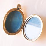 Ciondolo portafoto antico di forma ovale con lamina in oro giallo 9K su metallo e con smalti blu, primi del ‘900