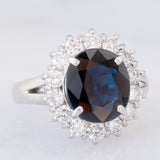 Anello a margherita vintage in platino con zaffiro (4.30ct) e diamanti (1.05ctw), anni ‘80