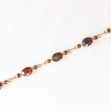 Braccialetto semirigido vintage in oro giallo 8K con granati (7ctw ca.), anni ‘60/‘70