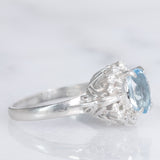Anello a margherita vintage in platino con acquamarina (0.93ct) e diamanti (0.29ctw), anni ‘80