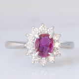 Anello a margherita vintage in platino con rubino (0.62ct) e diamanti (0.36ctw), anni ‘70/‘80