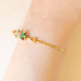 Braccialetto semirigido in oro giallo 14K con smeraldi (0.50ctw ca.) e diamanti (0.02ctw ca.), anni ‘70/‘80