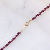 Collana moderna con granati, perla bianca e oro giallo 14K