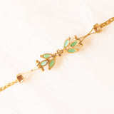 Braccialetto semirigido in oro giallo 14K con smeraldi (0.50ctw ca.) e diamanti (0.02ctw ca.), anni ‘70/‘80