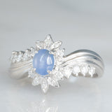 Anello a margherita vintage in platino con zaffiro stellato (0.71ct) e diamanti (0.27ctw), anni ‘80/‘90