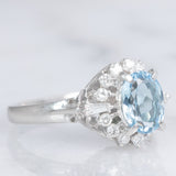 Anello a margherita vintage in platino con acquamarina (0.93ct) e diamanti (0.29ctw), anni ‘80