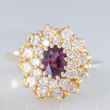 Anello a fiore vintage in oro giallo 14K con rubino (1ct ca.) e diamanti di taglio brillante (0.70ctw ca.), anni ‘70