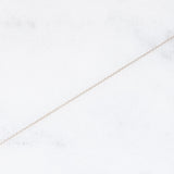 Collier vintage in stile antico con catenina in oro bianco 18K e con ciondolo in oro giallo 18K e argento con rubino (0.60ct ca.) e diamante di taglio rosetta (0.10ct ca.), anni ‘50/‘60