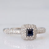 Anello a margherita vintage in oro bianco 9K con zaffiro di taglio carré (0.20ct ca.) e diamanti (0.38ctw ca.), anni ‘90/anni ‘2000