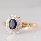 Anello a margherita vintage in oro giallo e bianco 9K con zaffiro (0.60ct ca.) e diamanti (0.12ctw ca.), anno 1991