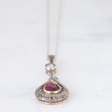 Collier vintage in stile antico con catenina in oro bianco 18K e con ciondolo in oro giallo 18K e argento con rubino (0.60ct ca.) e diamante di taglio rosetta (0.10ct ca.), anni ‘50/‘60