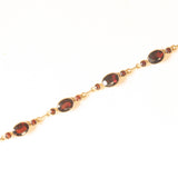 Braccialetto semirigido vintage in oro giallo 8K con granati (7ctw ca.), anni ‘60/‘70