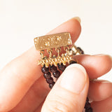 Braccialetto vintage con quattro fili di granati e con chiusura in oro giallo 14K con perline, anni ‘50/‘60