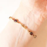 Braccialetto semirigido vintage in oro giallo 8K con granati (7ctw ca.), anni ‘60/‘70