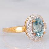Anello a margherita in oro giallo 9K con zircone azzurro (1.83ct ca.) e zirconi bianchi