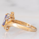 Anello bypass in oro giallo 9K con tanzaniti (0.91ctw ca.) e zaffiri bianchi
