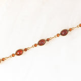 Braccialetto semirigido vintage in oro giallo 8K con granati (7ctw ca.), anni ‘60/‘70