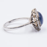 Vintage 18K gold ring with central cabochon sapphire and diamonds, 1960s