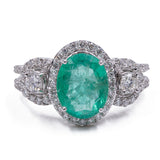 Anello in oro 18K con smeraldo centrale (3ct) e tempestato di diamanti (1.23ctw)