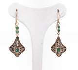 Liberty earrings in gold and silver with emeralds and diamond rosettes.