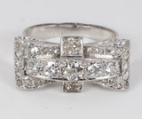 Antique 18k white gold ring with central old cut diamonds (0.91 ct tot) and diamond rosettes. 30s