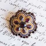 Spilla vintage in oro 18K con granati e smalti blu, anni '50
