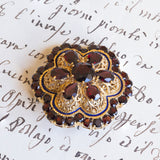 Spilla vintage in oro 18K con granati e smalti blu, anni '50