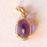 Lotto comprendente ciondolo in oro 18K con ametista, ciondolo in oro 18K a forma di “Uomo della Luna” in oro 18K e ciondolo in oro 9K a forma di elefantino