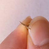 Lotto comprendente ciondolo in oro 18K con ametista, ciondolo in oro 18K a forma di “Uomo della Luna” in oro 18K e ciondolo in oro 9K a forma di elefantino