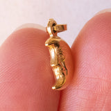 Lotto comprendente ciondolo in oro 18K con ametista, ciondolo in oro 18K a forma di “Uomo della Luna” in oro 18K e ciondolo in oro 9K a forma di elefantino