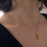 Ciondolo “Mano di Fatima” vintage in oro 18K con rubino, anni ‘70