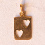 Lotto comprendente ciondolo in oro 18K con zircone e ciondolo a forma di carta di due di cuori in oro 18K