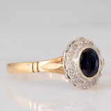 Anello a margherita vintage in oro giallo e bianco 9K con zaffiro (0.60ct ca.) e diamanti (0.12ctw ca.), anno 1991