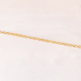 Collana con catenina in argento dorato e con tre ciondoli a forma di delfino in oro giallo 18K, di ancora in oro giallo 18K e di tartaruga in oro giallo 14K