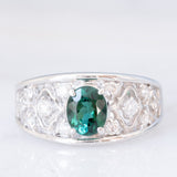 Anello a fascia in platino con tormalina verde (1.13ct) e diamanti (0.38ctw) e con lavorazioni a traforo, anni '90/anni '2000