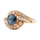 ANELLO TOURBILLON VINTAGE IN ORO GIALLO 14K CON ZAFFIRO (1.20CT CA.) E DIAMANTI (0.29CTW CA.), ANNI ‘80