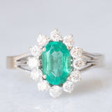 Anello a margherita in oro bianco 18K con smeraldo (1ct ca.) e diamanti di taglio brillante (0.50ctw ca.), anni ‘60