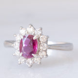 Anello a margherita vintage in platino con rubino (0.62ct) e diamanti (0.36ctw), anni ‘70/‘80